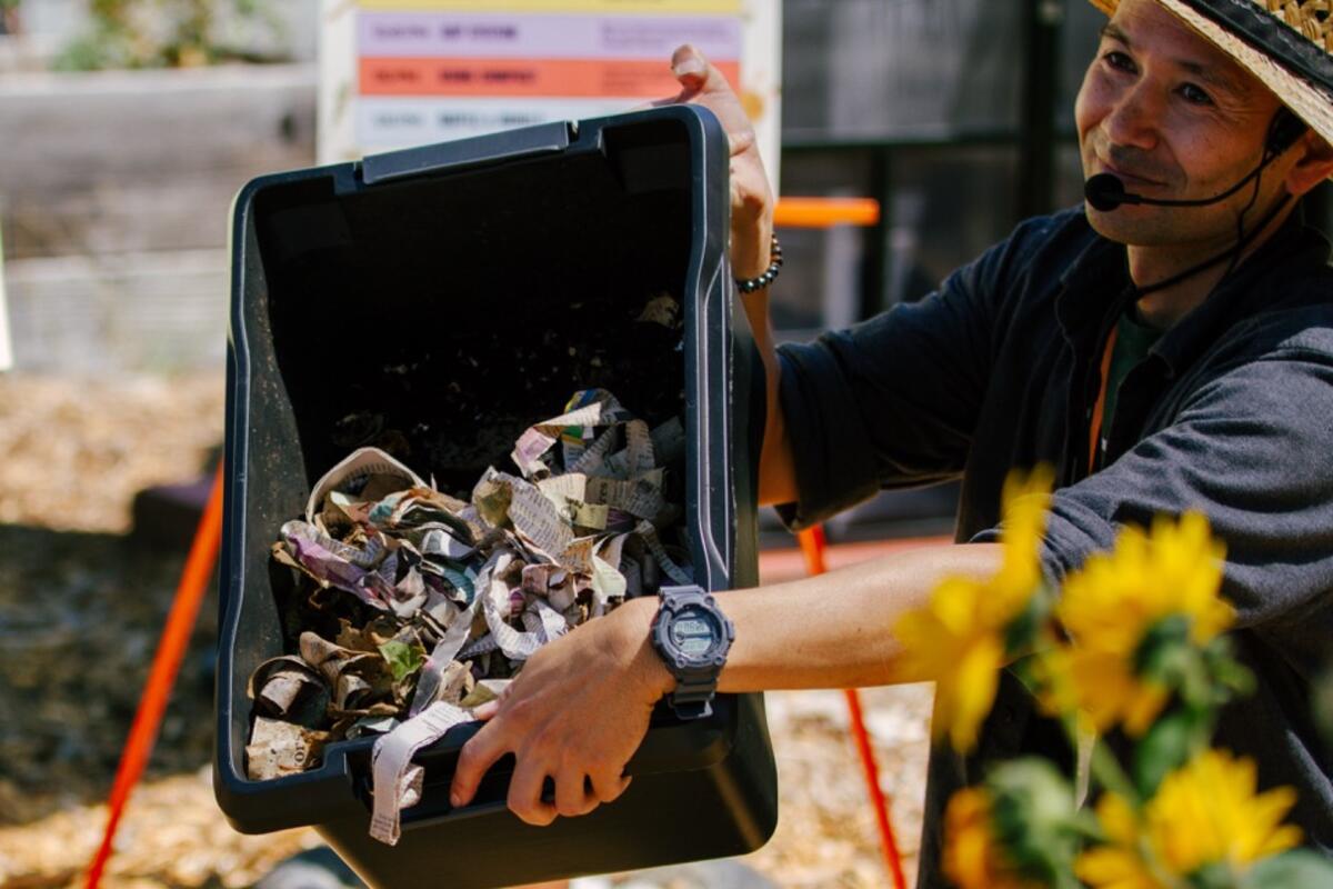 Showing the inside of a compost bin at a garden workshop