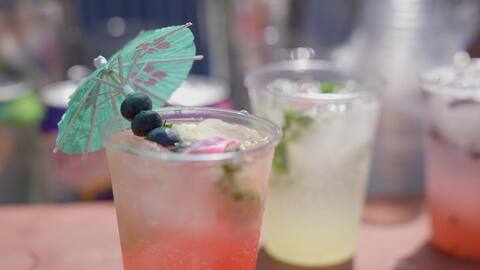 Berry lemonade with a paper umbrella at Sips and Scents