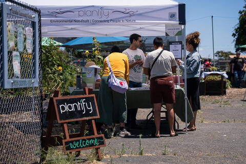 Welcome tent and chalkboard at the garden gate